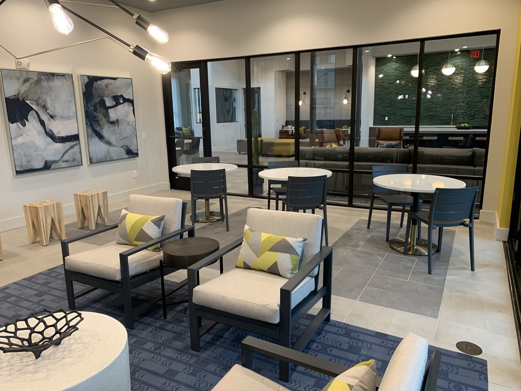a seating area of a restaurant with tables and chairs
